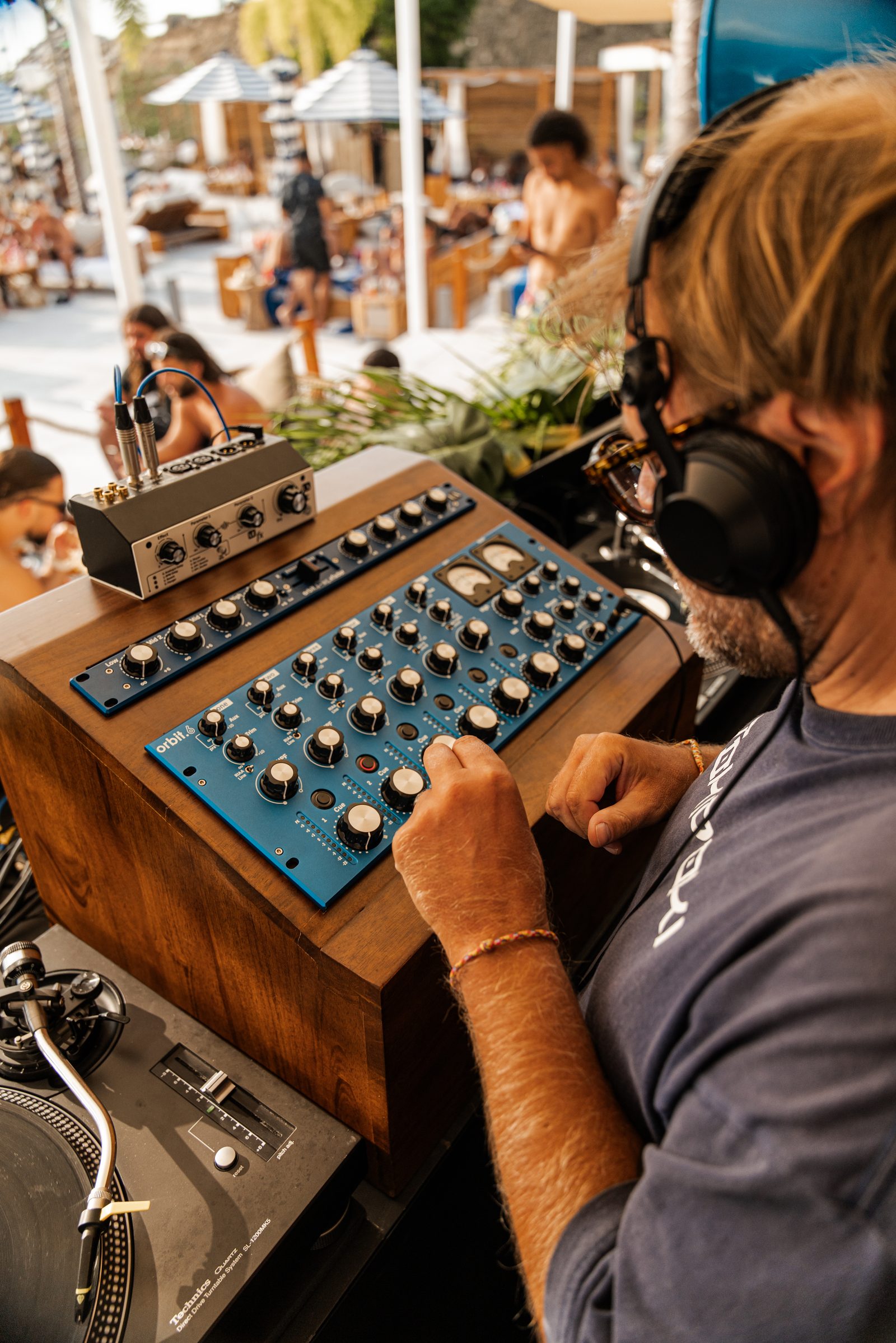 DJ Rudi mixing on a rotary mixer and Technics turntables at Fira Beach Club, Phuket