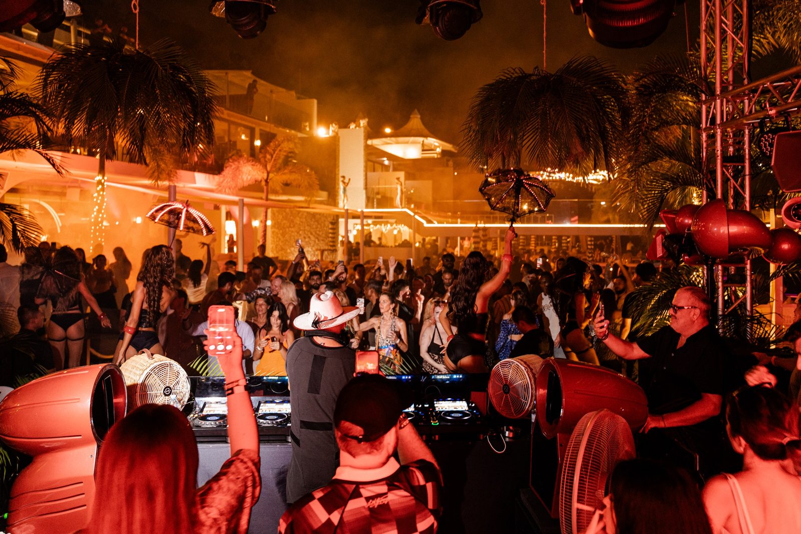 Crowd dancing at a night pool party at Fira Beach Club, the luxury beach club in Phuket where DJ Rudi is a resident DJ
